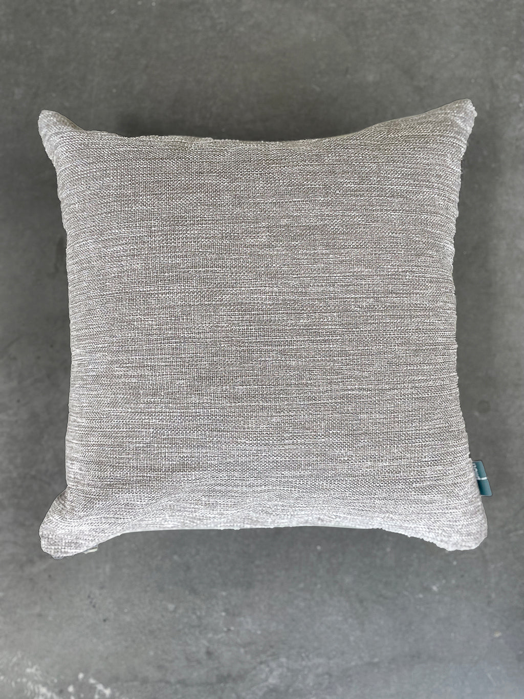 Gray textured pillow on a gray background