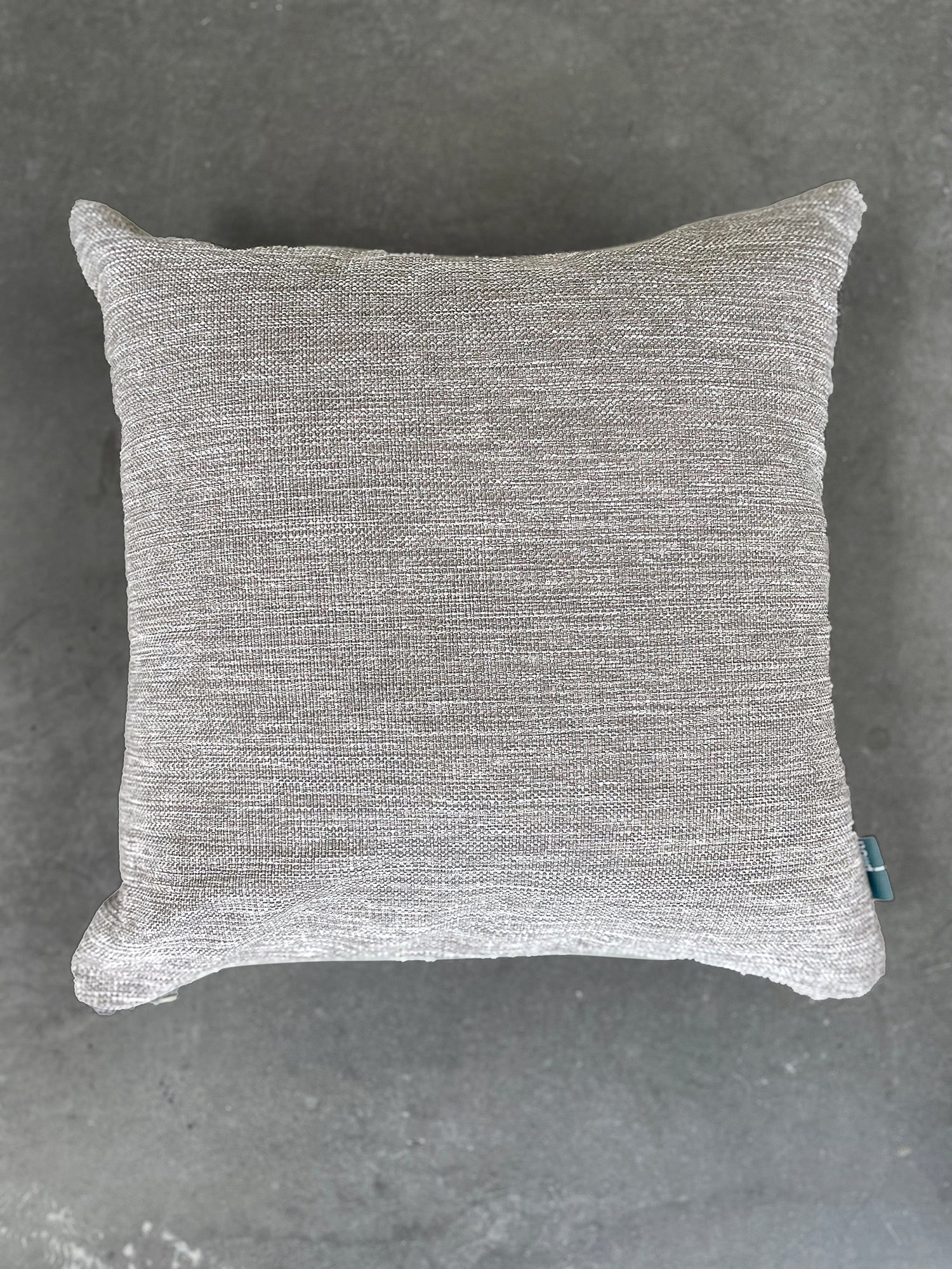 Gray textured pillow on a gray background