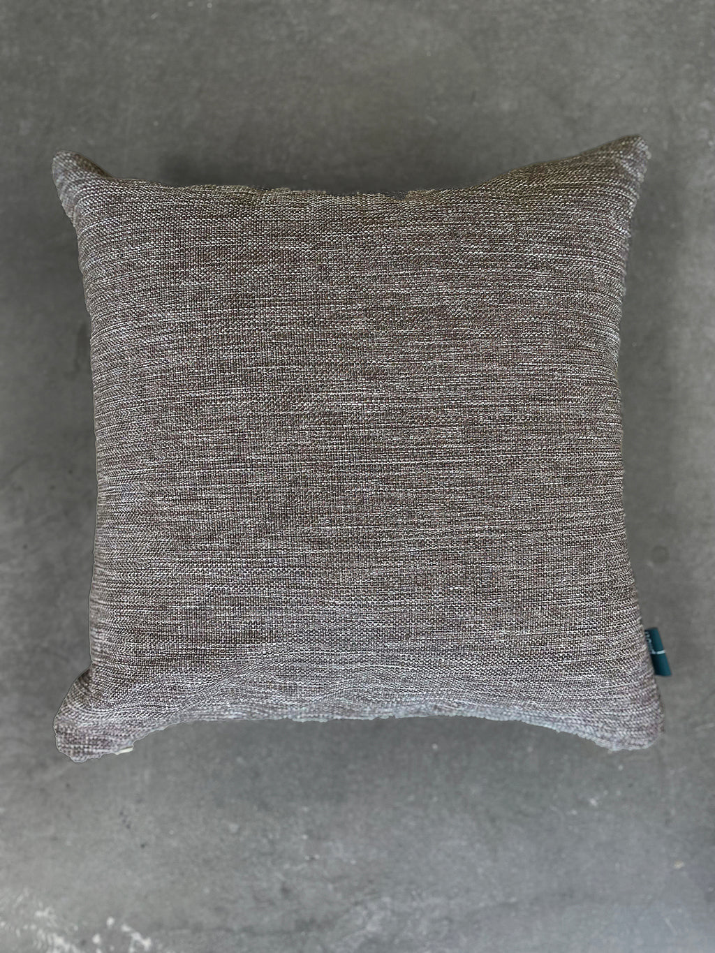 Textured gray pillow on a gray background