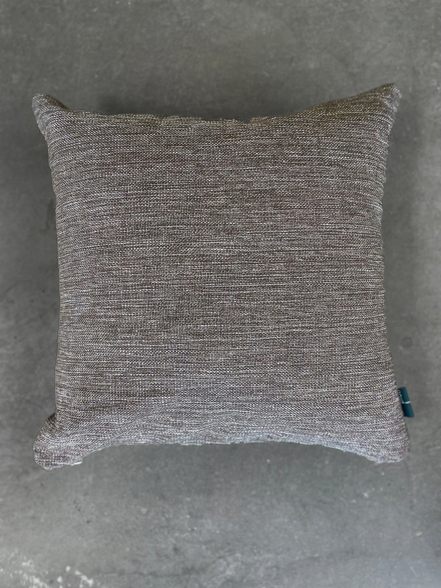 Textured gray pillow on a gray background