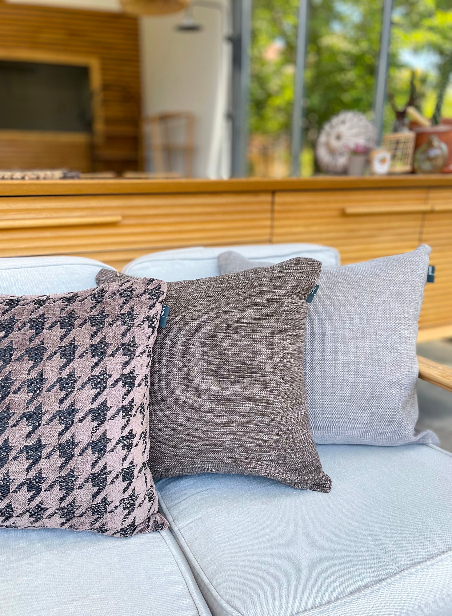 Decorative pillows on a sofa with a blurred background